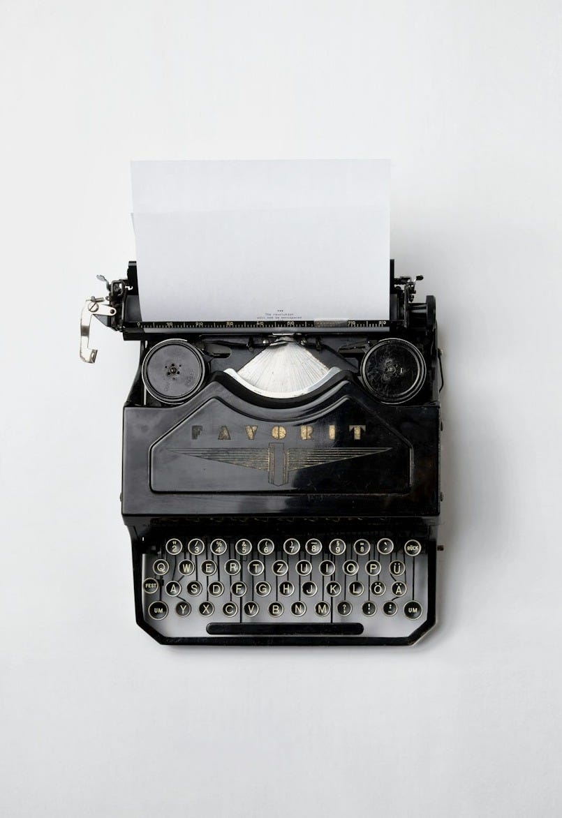 black Fayorit typewriter with printer paper