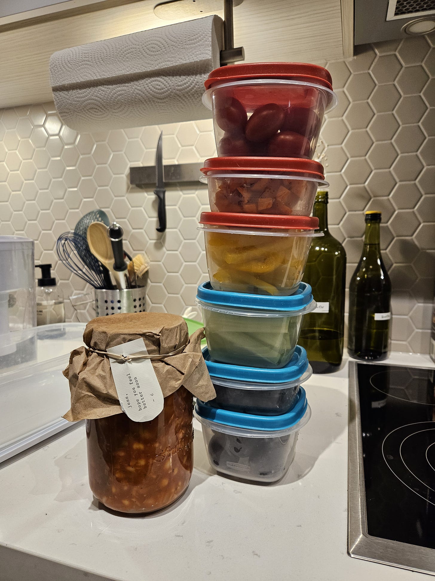 pic of 6 tupperwares of rainbow colorued veggies and a jar of minestrone soup with a tag that says, feel better soon jess from danilla