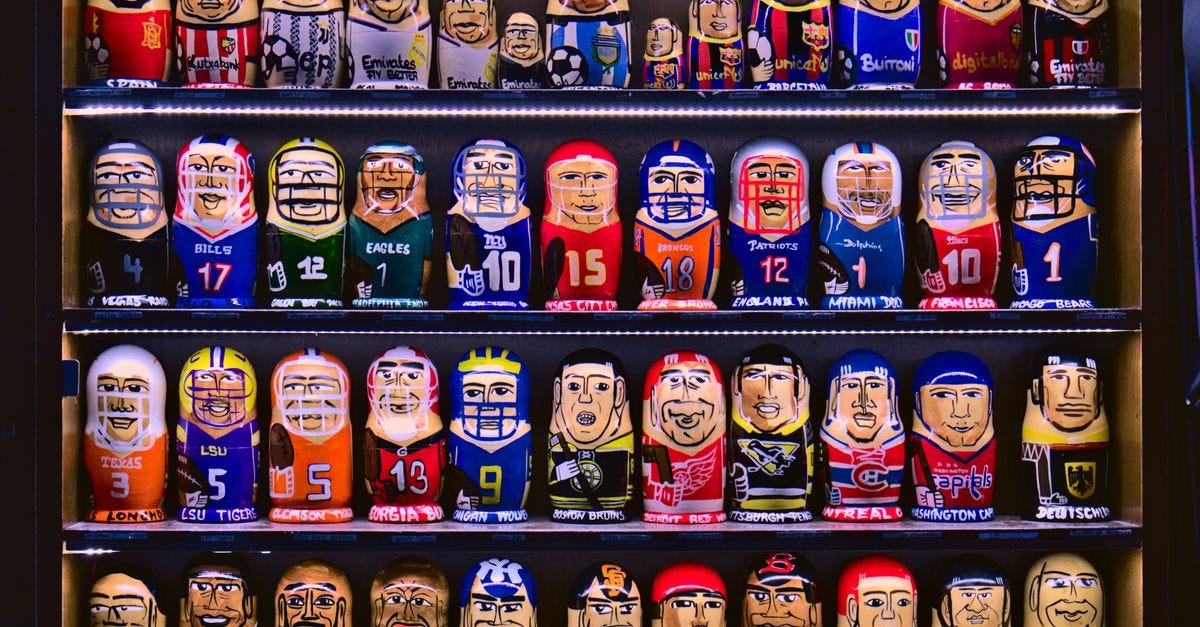 Photo: Rodi Düger / Pexels Colorful nesting dolls depicting various sports teams displayed on shelves.