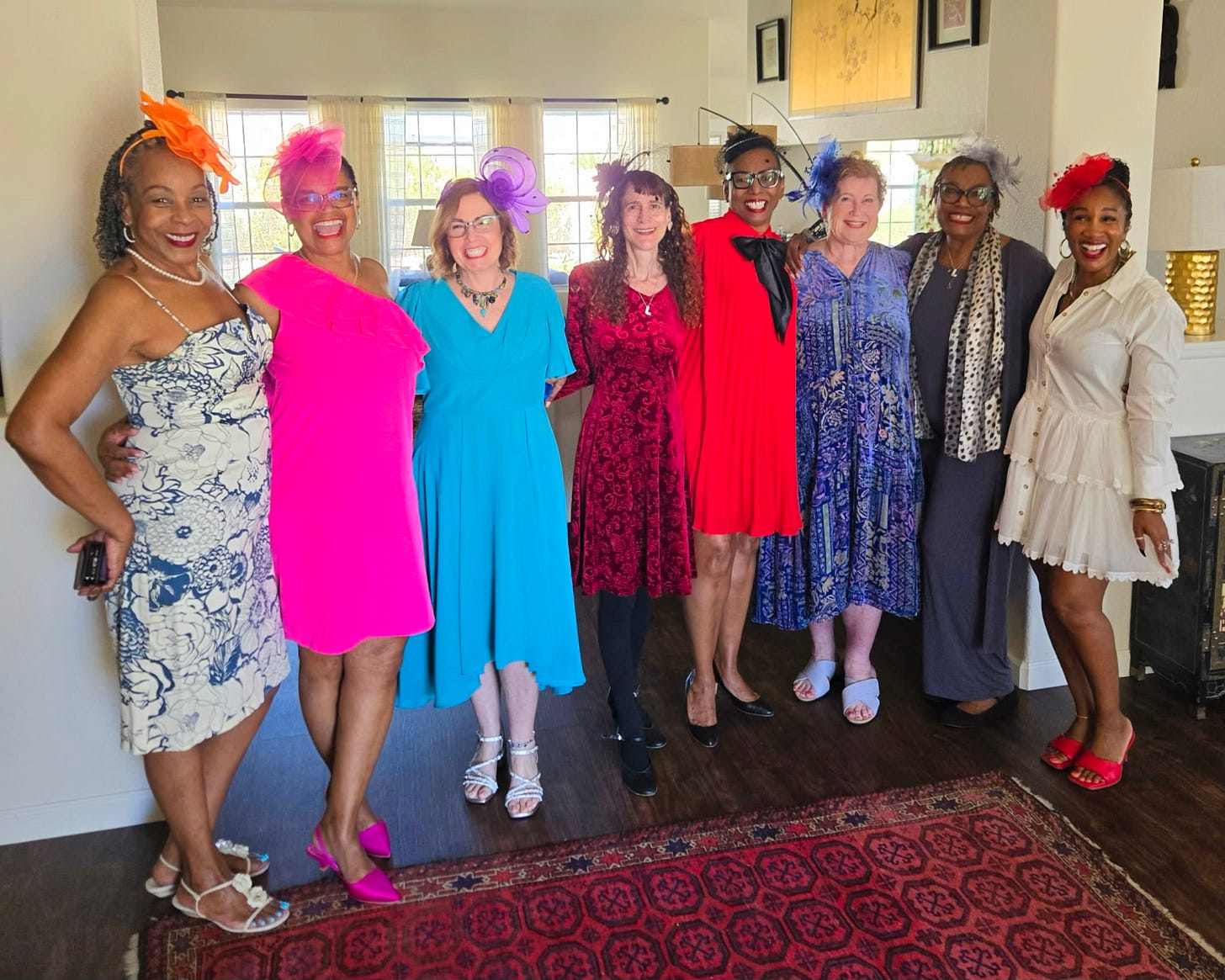 Group of women entrepreneurs and community leaders wearing colorful fascinator hats at a Las Vegas tea gathering, representing friendship, mentorship, and the growing influence of women founders shaping culture and business.