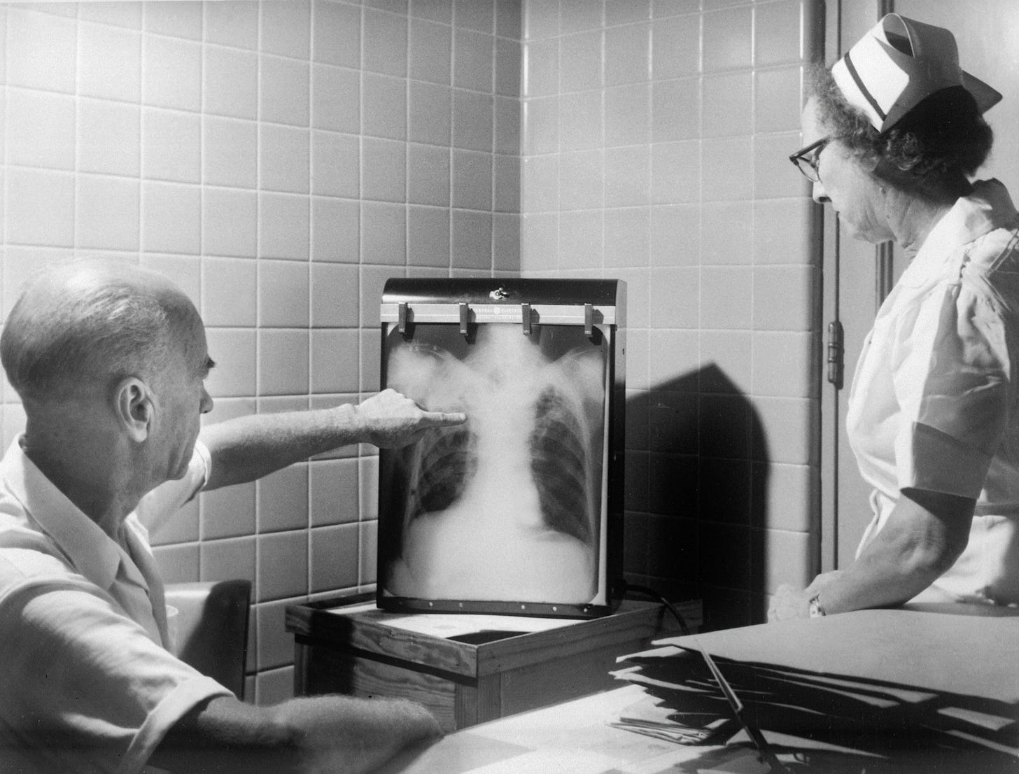 Medical folks looking at an check x-ray.