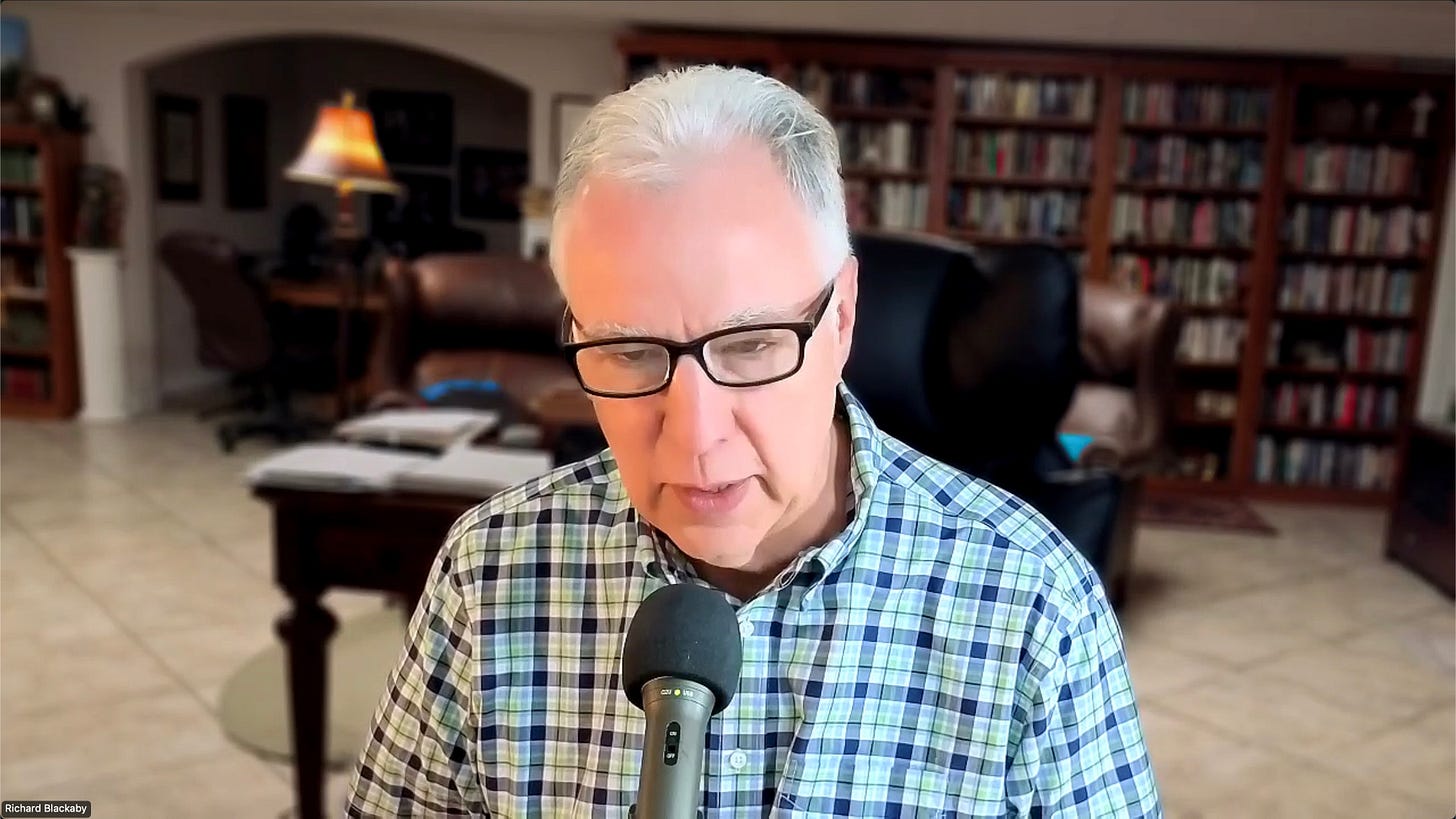 Image of a man in an office speaking into a microphone for an online Bible devotion.e