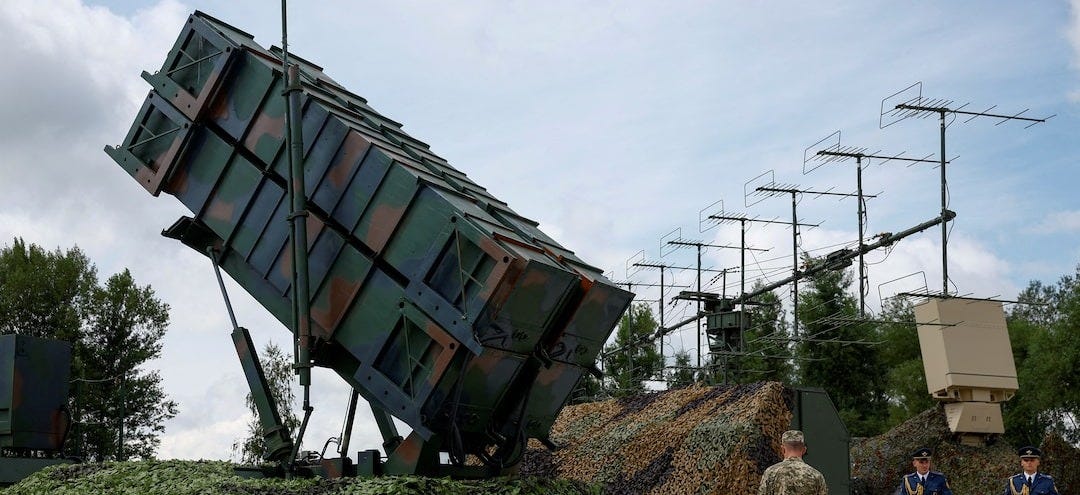Ukrainian service members walk next to a launcher of a Patriot air defence system an undisclosed location in Ukraine Ukrainian service members walk next to a launcher of a Patriot air defence system an undisclosed location in Ukraine