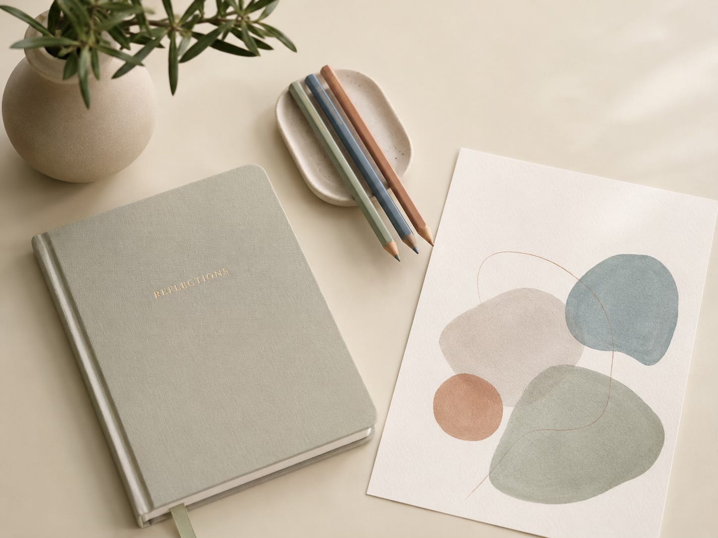 Notebook with simple coloured shapes and pencils, representing gentle reflection and creative emotional processing.