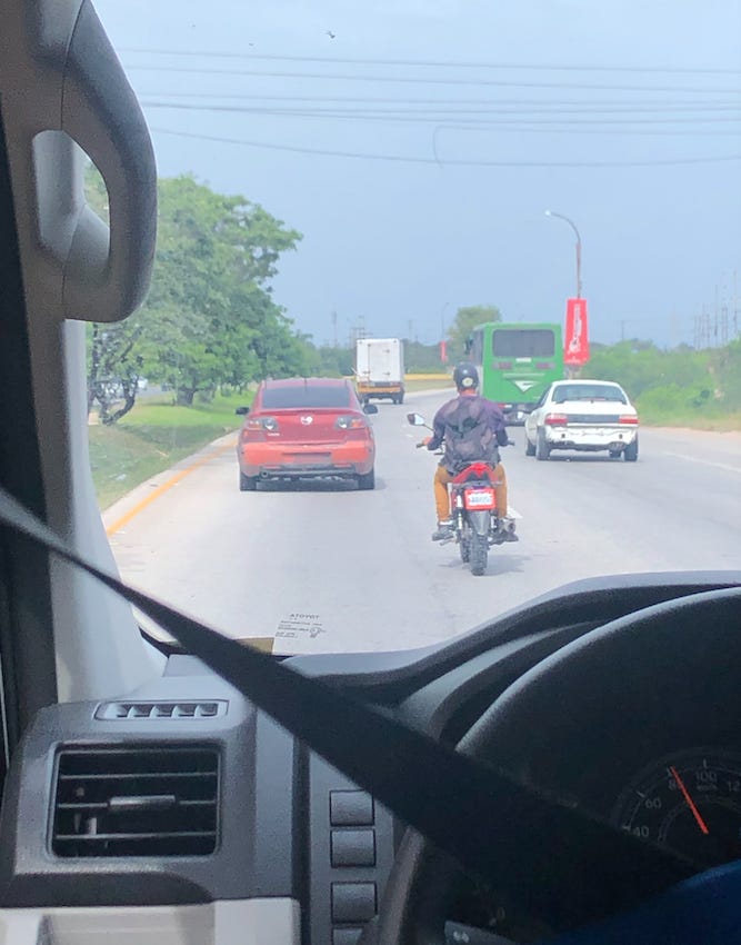 A person on a motorcycle on the road

AI-generated content may be incorrect.