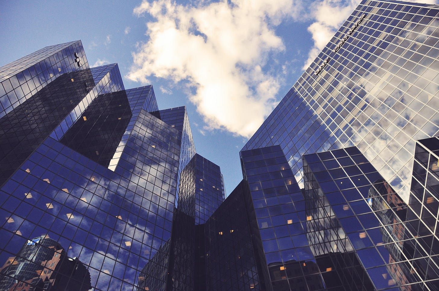 Clouds reflected in the blue glass of skyscrapers