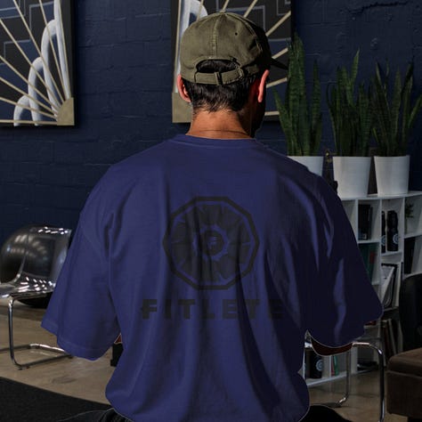 The toned fitlete logo sits on top of a shirt with its same color at a different shade or tone.