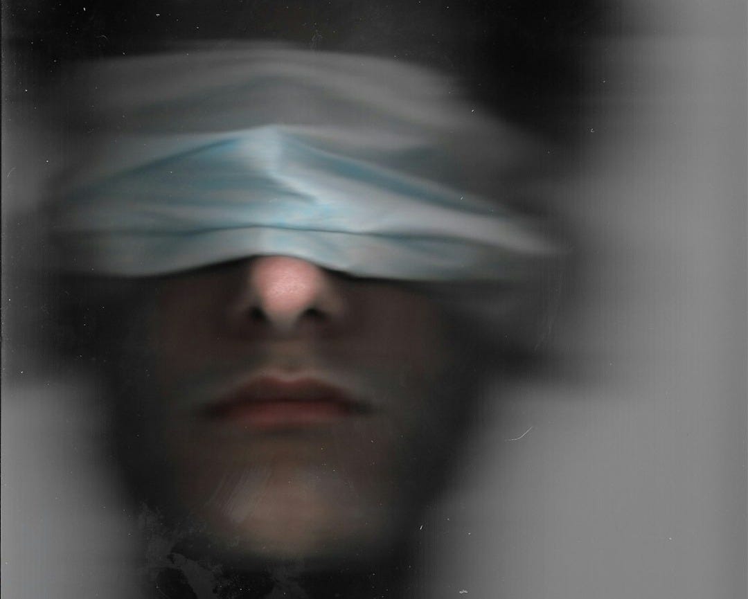 a man with a blindfold over his eyes