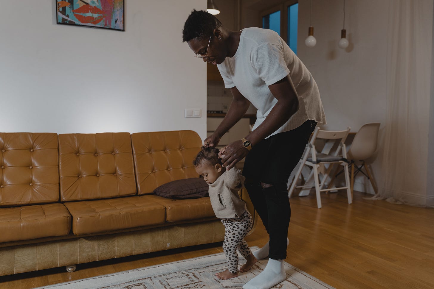 father helping baby take first steps father helping baby take first steps