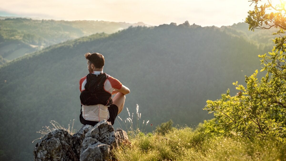 runner resting on mountain