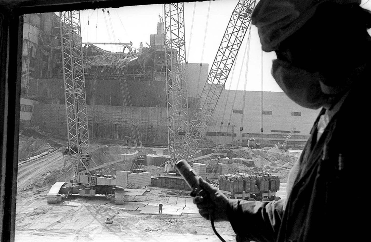 Human 'liquidators' bravely clear radioactive debris from Reactor No. 3's roof, where robots failed due to extreme radiation. Workers faced life-threatening doses in mere seconds.