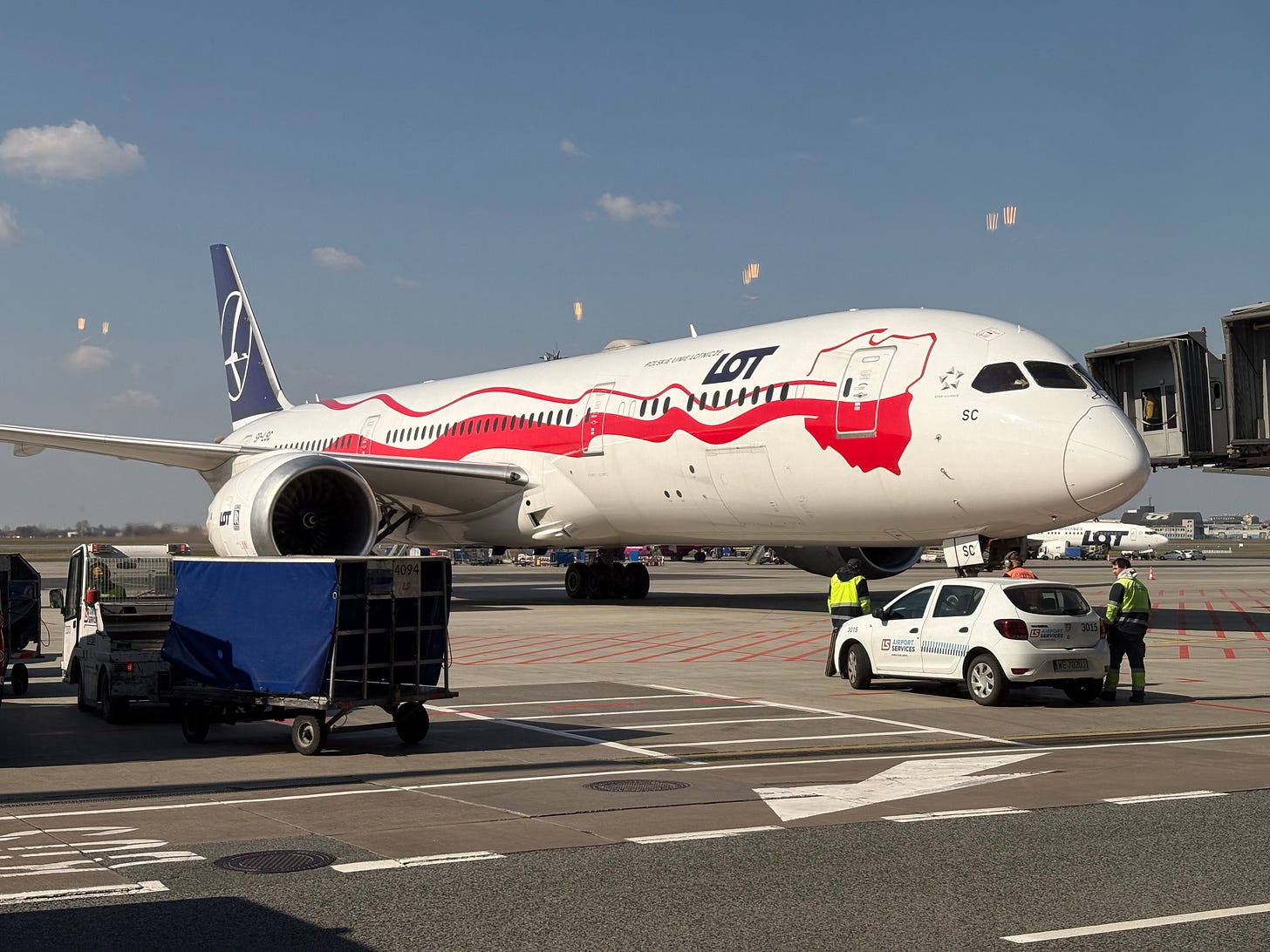 LOT B787 parking at Warsaw Chopin airport viewed from lounge.