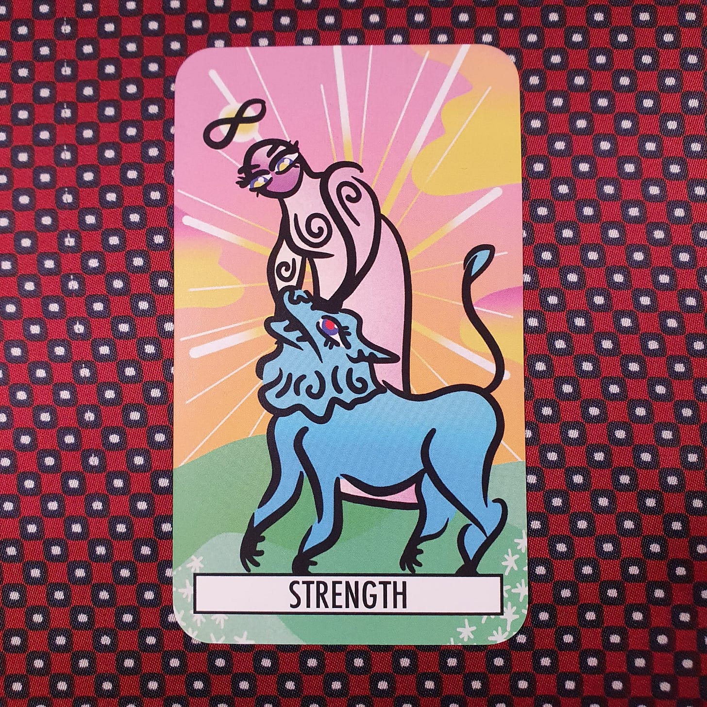 Strength tarot card featuring stylised figure gently holding a blue lion, colourful modern illustration - symbol of inner resilience discussed in creative practice interview. Strength tarot card featuring stylised figure gently holding a blue lion, colourful modern illustration - symbol of inner resilience discussed in creative practice interview.