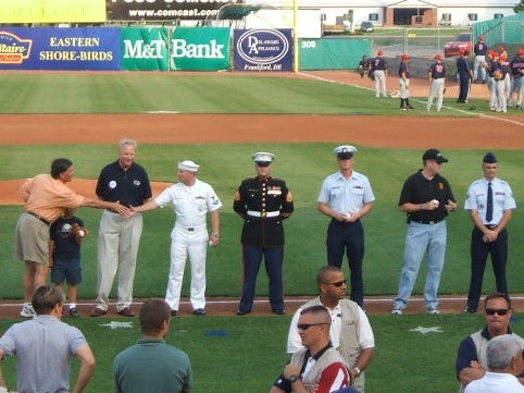 Governor Ehrlich greets the Navy's representative as the military is honored in a pregame ceremony. Governor Ehrlich greets the Navy's representative as the military is honored in a pregame ceremony.