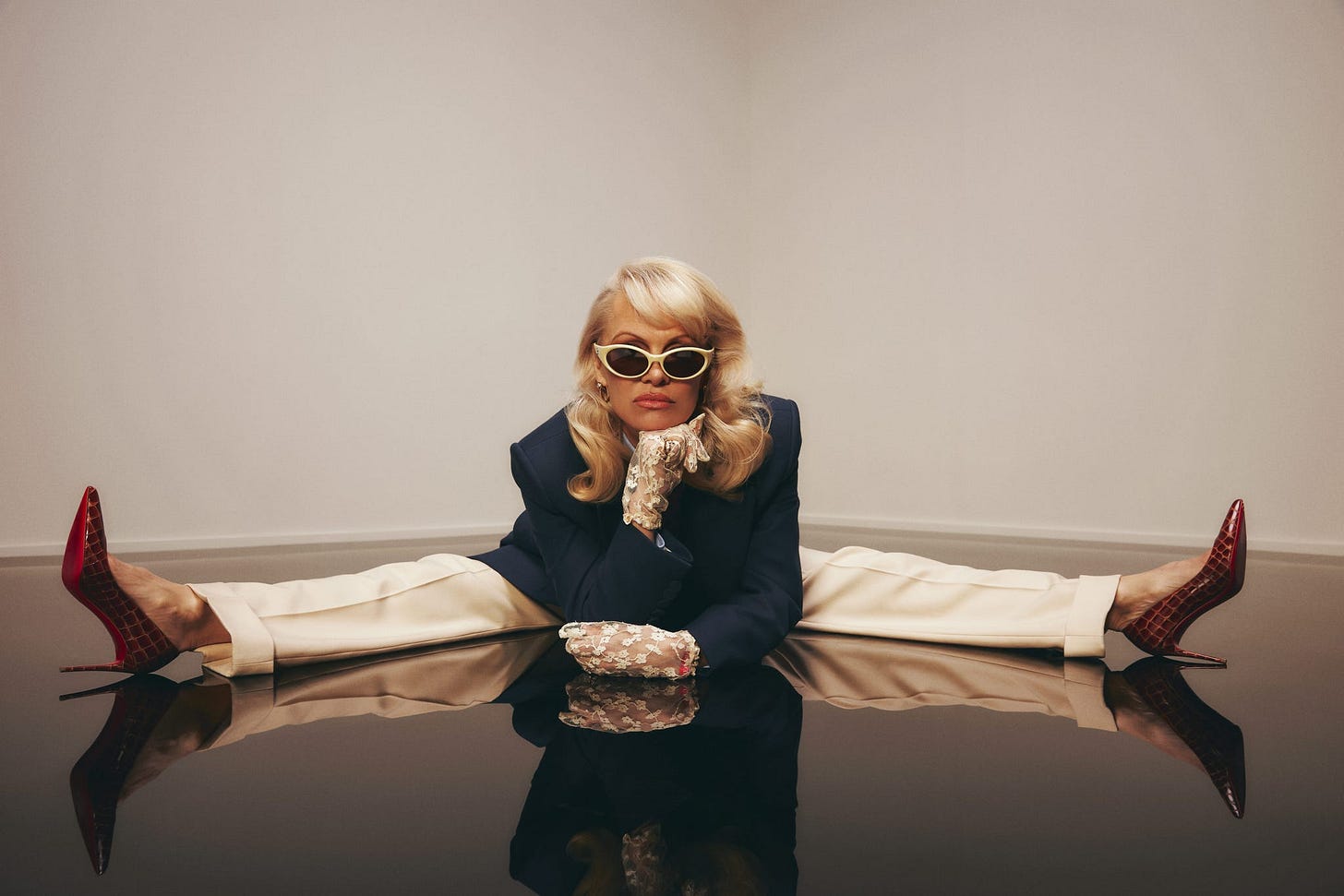 pamela anderson in a striking pose wearing elegant attire