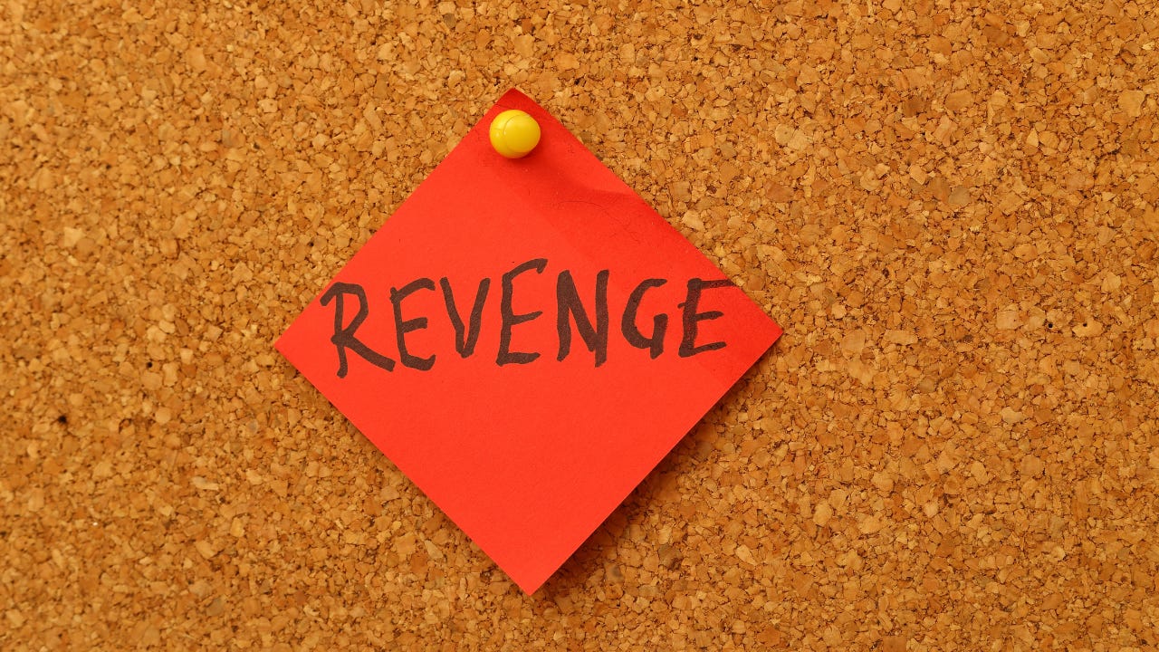 The word "Revenge" written on a red piece of paper. The word "Revenge" written on a red piece of paper.