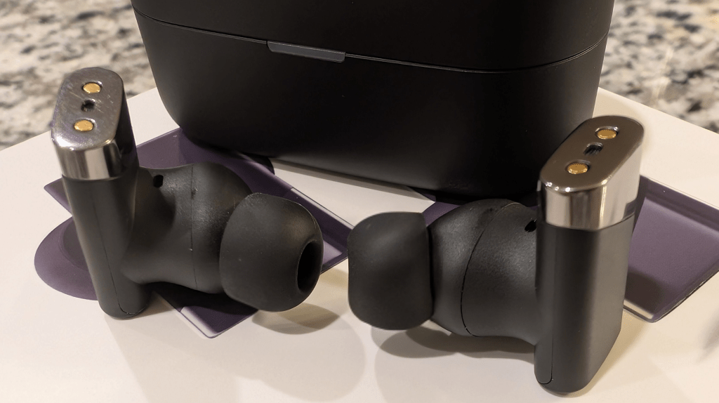Status Pro X review earbuds on top of the Pro X box. Status Pro X review earbuds on top of the Pro X box.