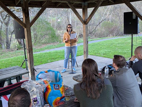 Images depicting the author reading at an open mic, a vase of dried lavender bathed in light from the setting sun, and the author's husband petting a black cat on one of their walks.