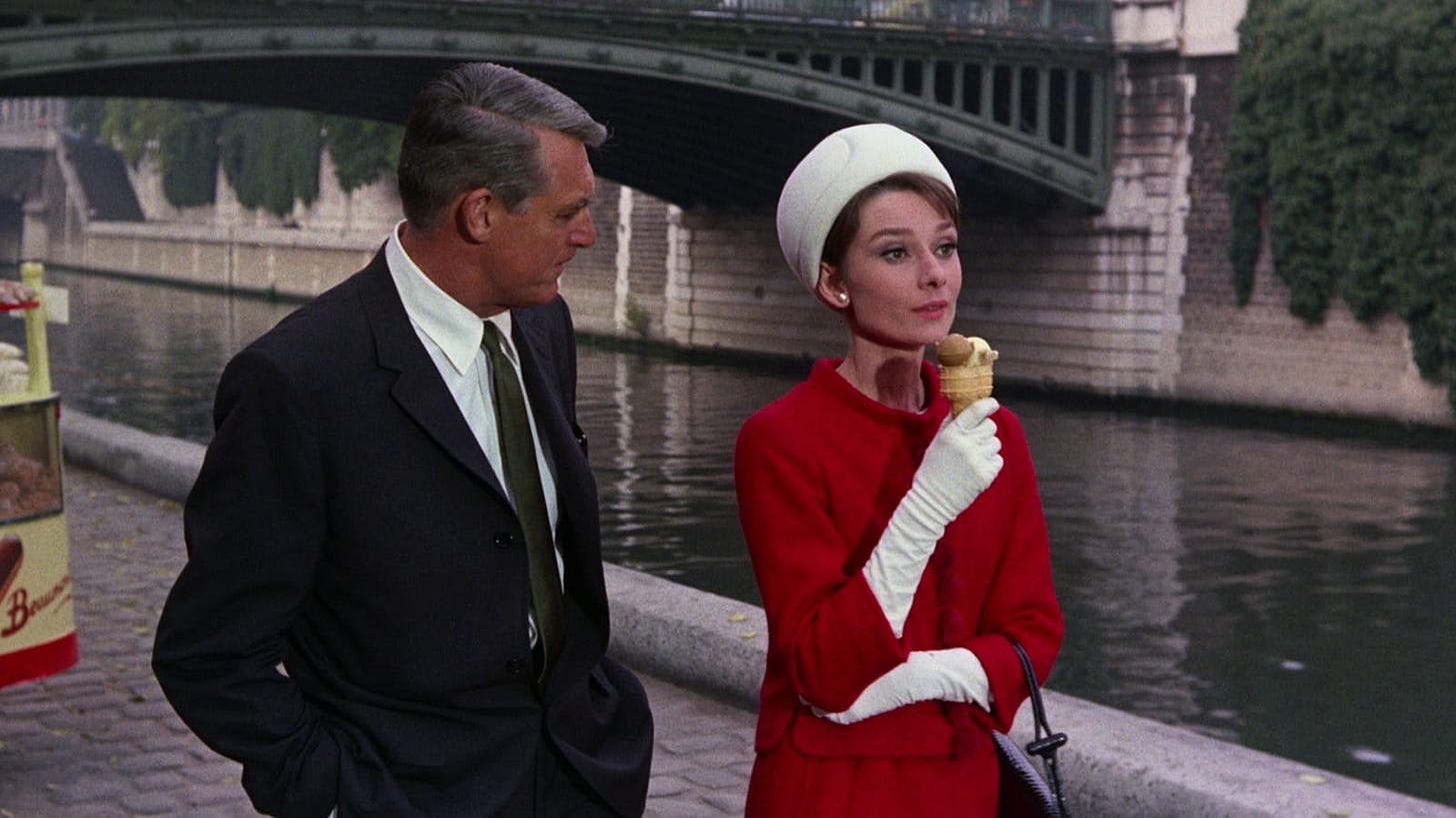 Cary Grant and Audrey Hepburn walk along the Seine river in Charade (1963)
