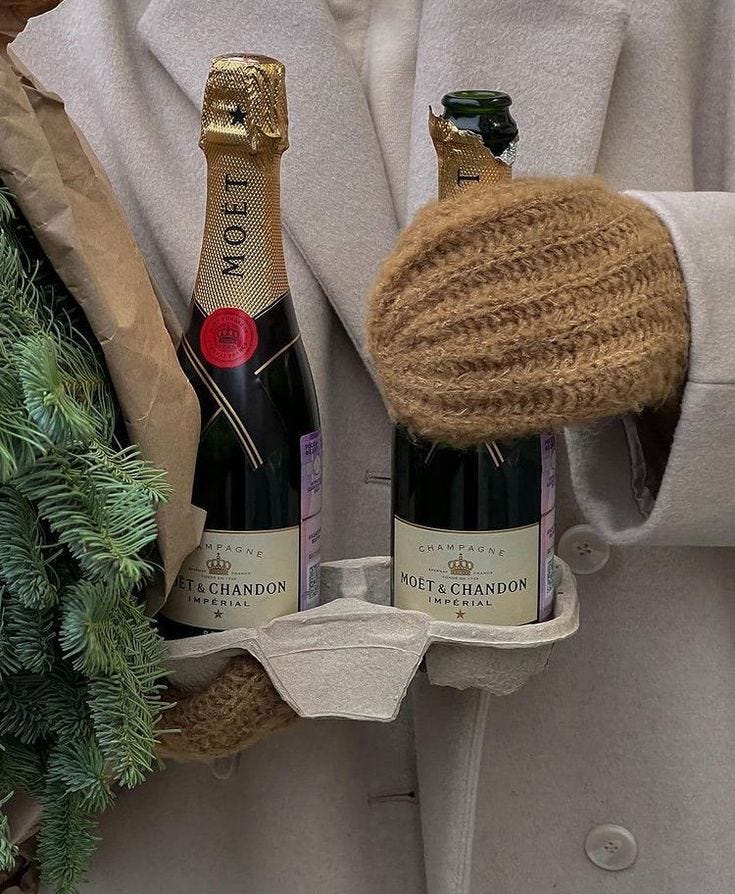 This may contain: a man holding two bottles of champagne in his hand This may contain: a man holding two bottles of champagne in his hand