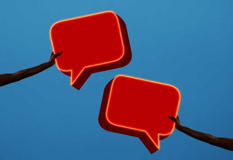 Arms holding two speech bubbles