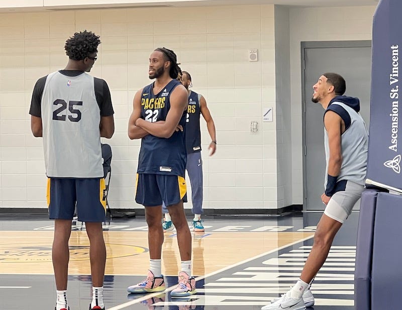 Jalen Smith, Isaiah Jackson and Tyrese Haliburton talking after practice.