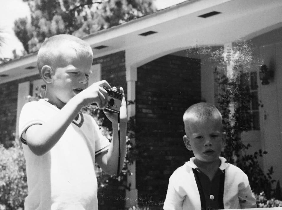 A child taking a picture of a child

Description automatically generated