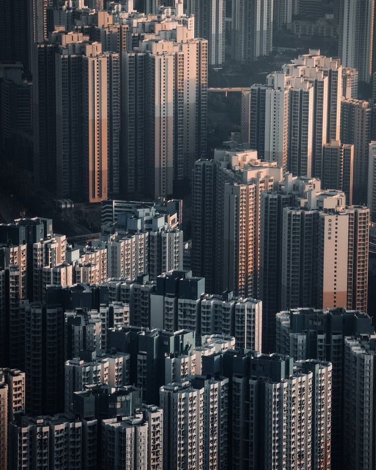 This may contain: an aerial view of many tall buildings in a large city with lots of windows and balconies