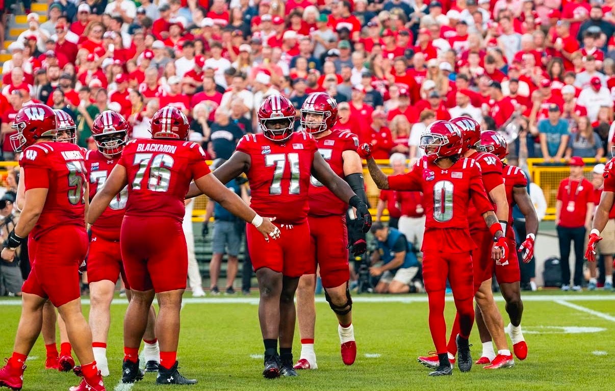 Wisconsin Badgers offense lines up on the field during a game against Notre Dame at Lambeau Field. Wisconsin Badgers offense lines up on the field during a game against Notre Dame at Lambeau Field.
