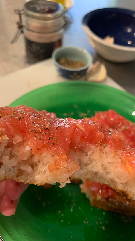 Image shows a green glass plate with a slice of bread smothered in pulped fresh tomato