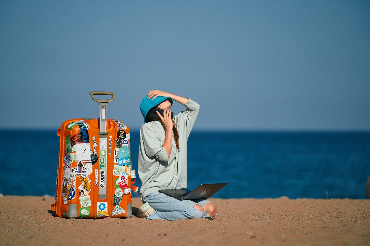 Professional sitting alone and reflecting on career dissatisfaction, illustrating the difference between being unhappy and being unhappy enough to make a major life change such as becoming a digital nomad Professional sitting alone and reflecting on career dissatisfaction, illustrating the difference between being unhappy and being unhappy enough to make a major life change such as becoming a digital nomad