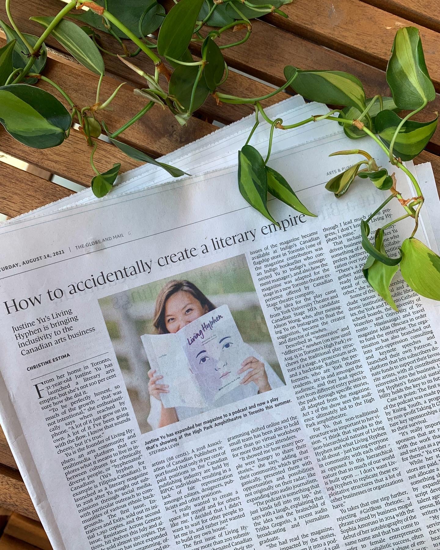 Newspaper clipping of Living Hyphen feature in The Globe and Mail. Leafy foliage at the top draping the newspaper.