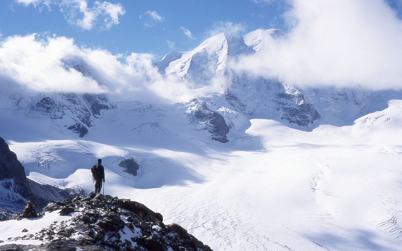 Snow peaks and glacier seen through clouds