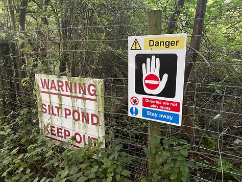 Warning signs for a silt pond and danger; a fox running past cars; men unloading meat from a van