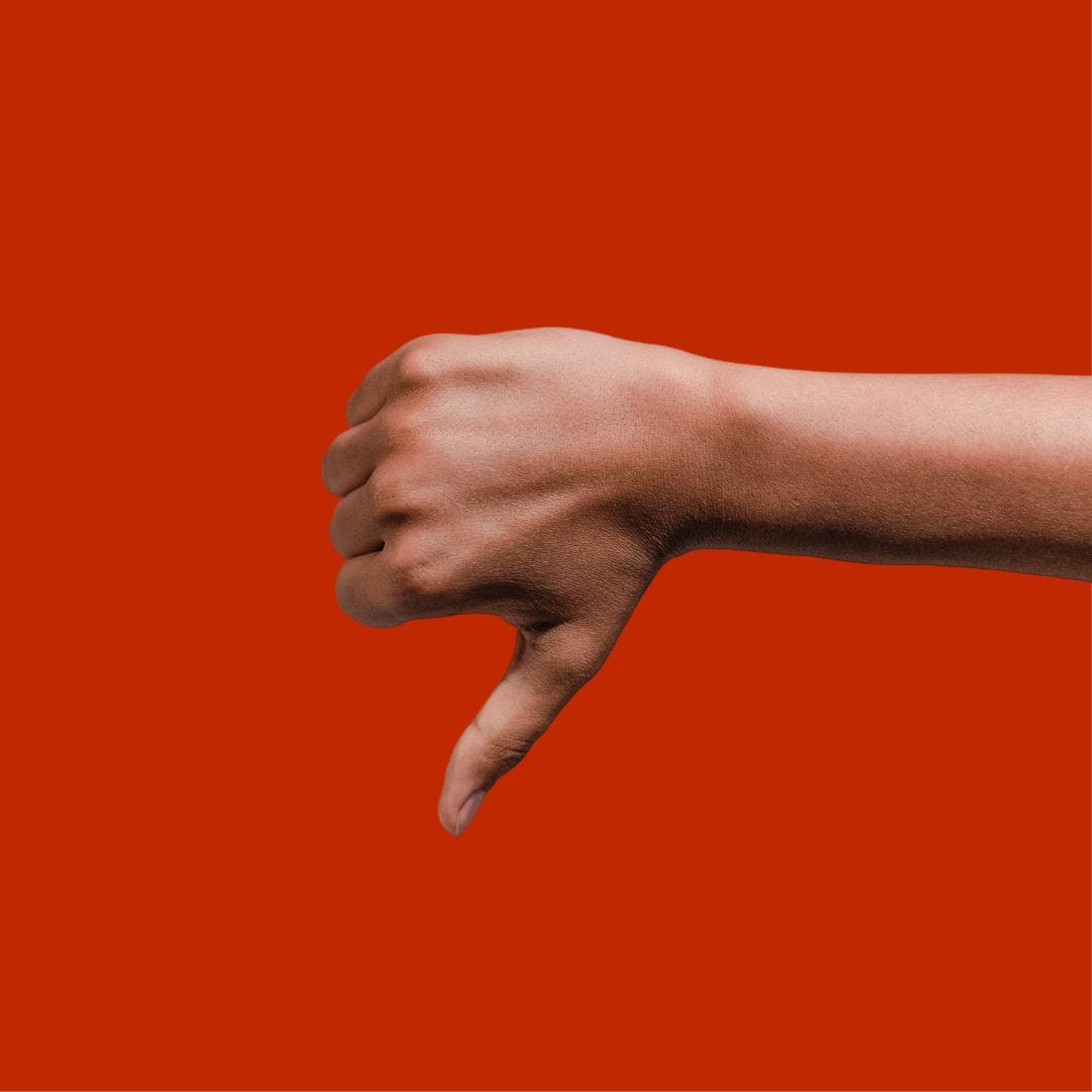 A hand making a thumbs down sign A hand making a thumbs down sign