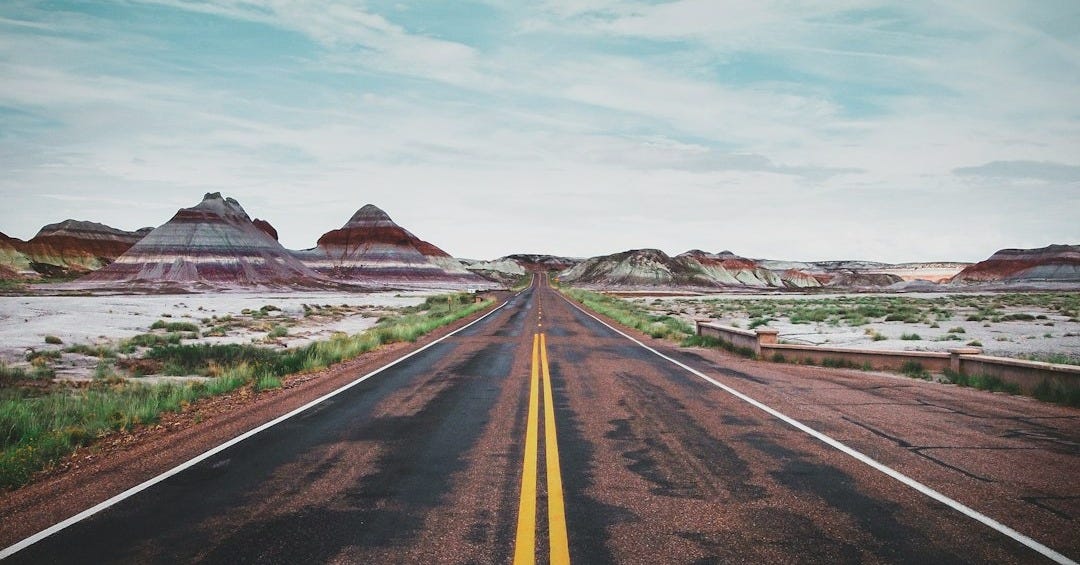 gray asphalt road under blue sky during daytime