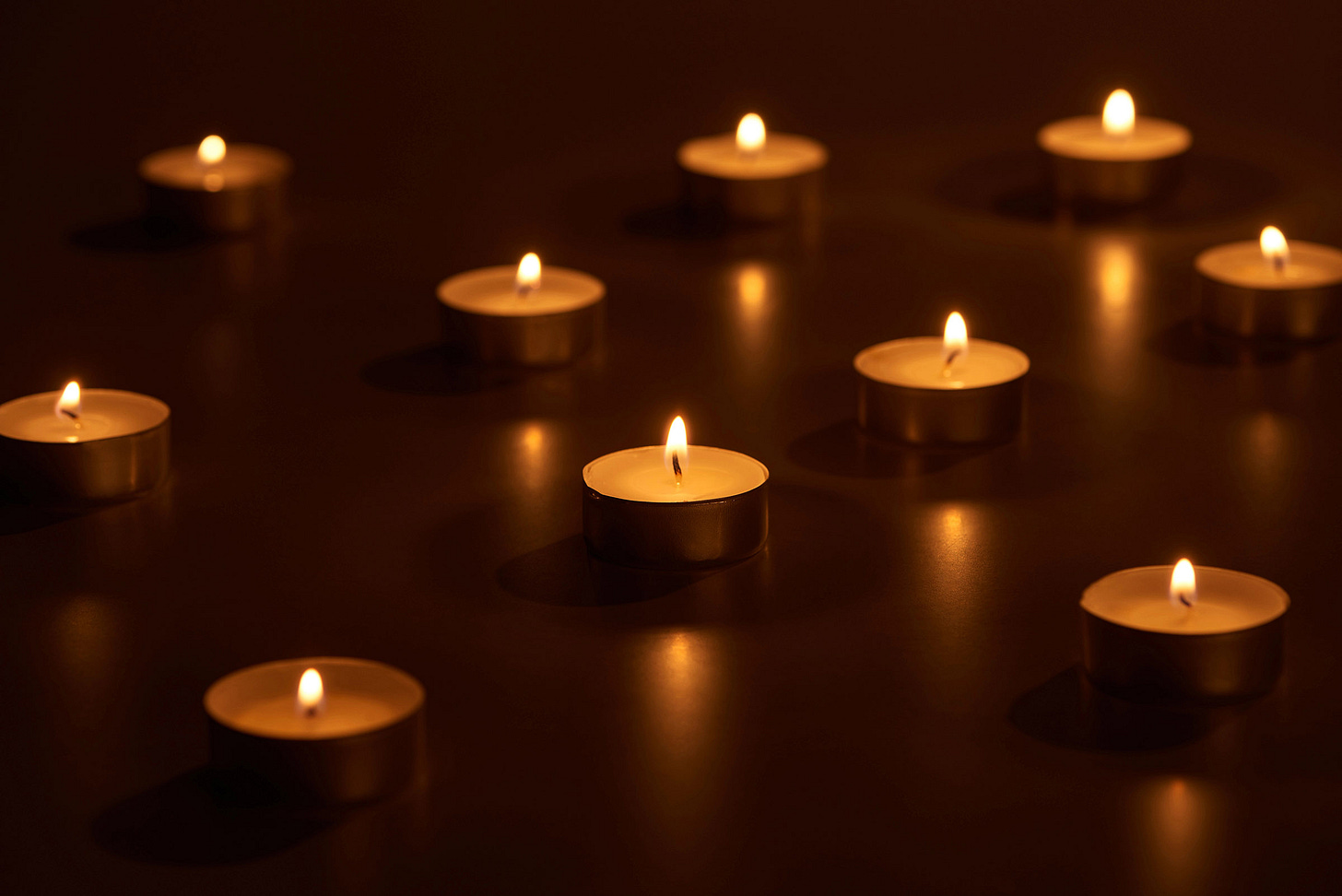 Many small candles burning in the darkness Many small candles burning in the darkness