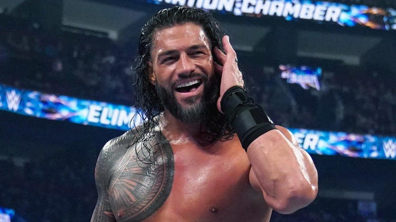 Roman Reigns listening to the fans at WWE Elimination Chamber 2023
