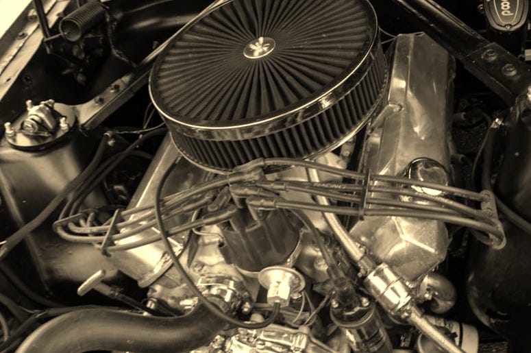 The engine compartment of a car with the hood up