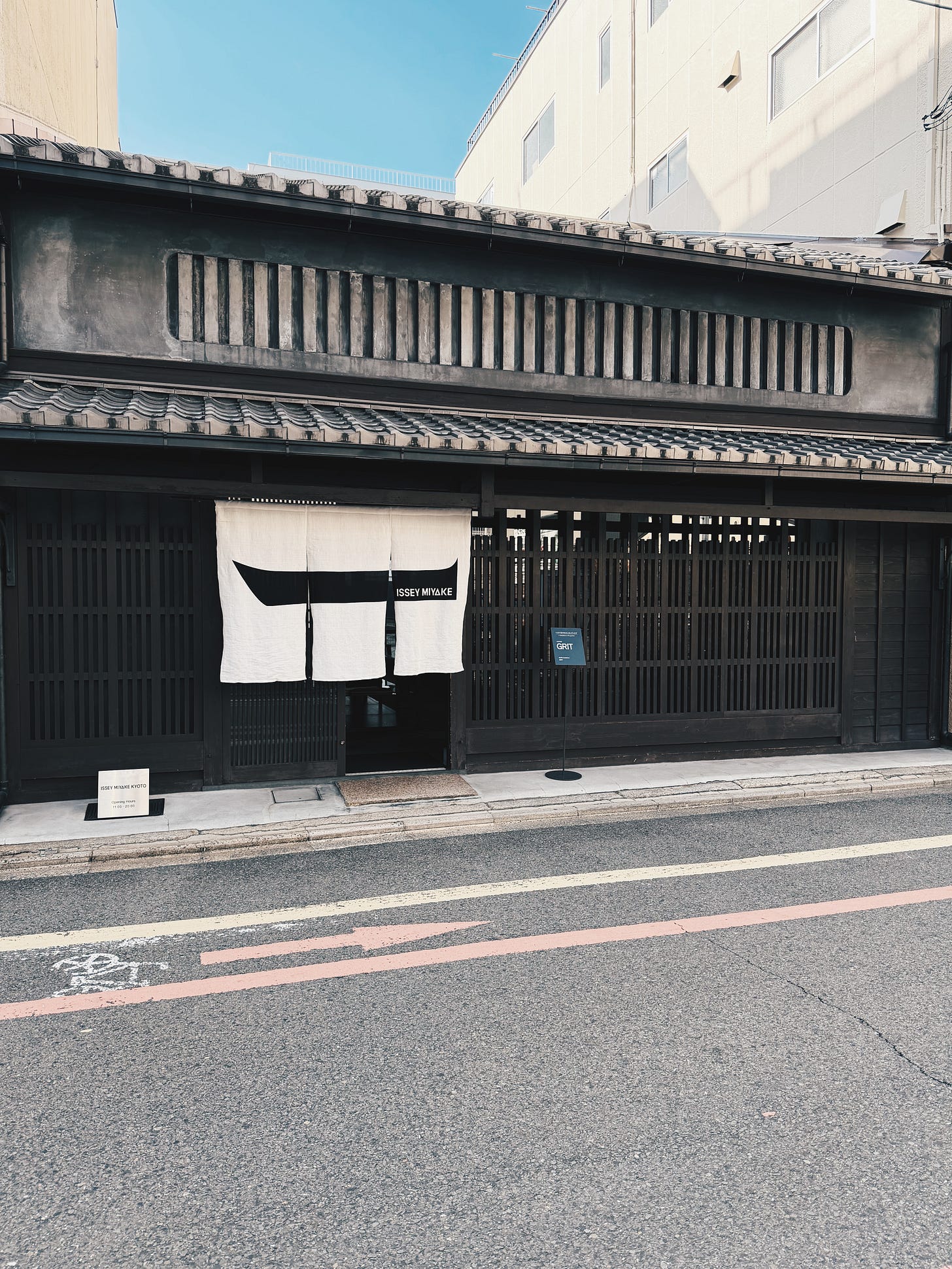 Historic machiya fashion boutique facade with wooden slats and noren curtain in Kyoto Historic machiya fashion boutique facade with wooden slats and noren curtain in Kyoto