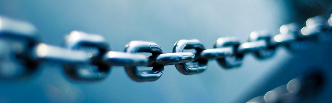 A photo of stainless steel chain symbolising the linked risk and dependencies in a supply chain A photo of stainless steel chain symbolising the linked risk and dependencies in a supply chain