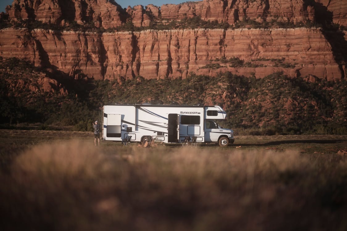 Free RV parked near Utah canyon under clear sky, perfect for adventure and travel enthusiasts. Stock Photo