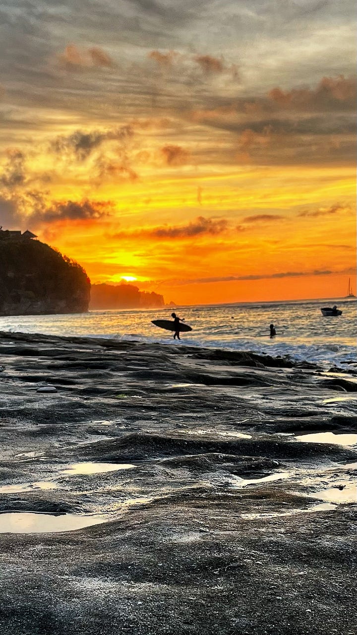 A sunset on a Bali beach and a construction site.