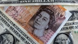 U.S. dollar bills are are pictured with British GDP notes on September 24, 2022 in Bath, England. 