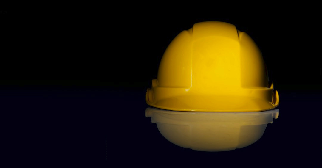 yellow safety hat on black surface