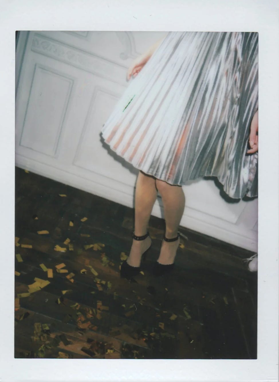 A woman in dress and heels shown in a festive environment A woman in dress and heels shown in a festive environment