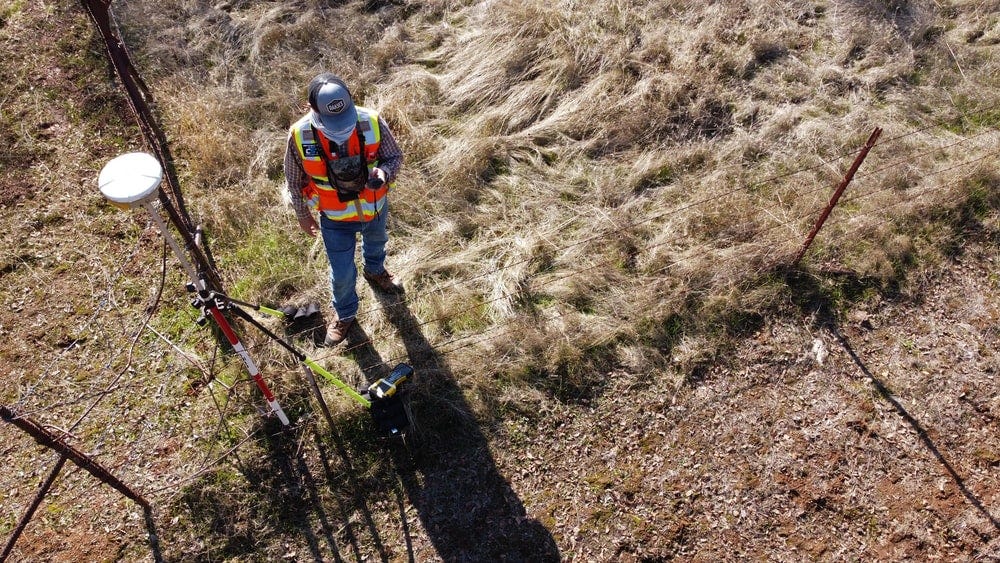 man in orange jacket and black helmet riding red bicycle on brown dirt road during daytime man in orange jacket and black helmet riding red bicycle on brown dirt road during daytime