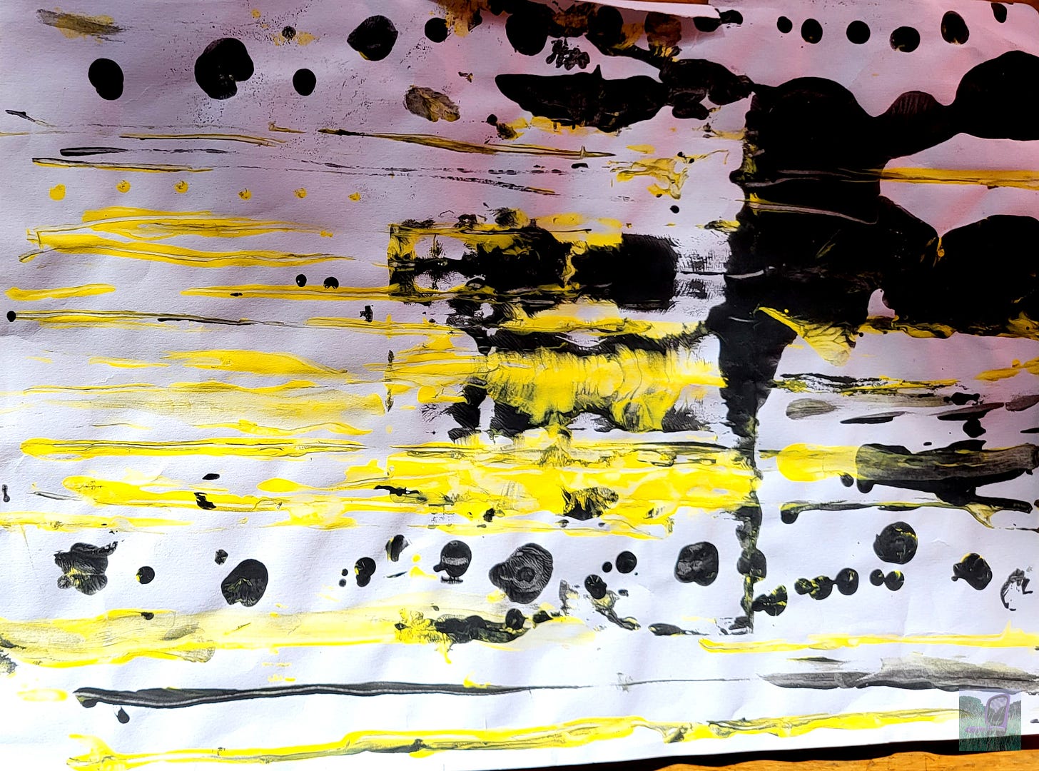 A slightly crumpled sheet of white paper with horizontal bright yellow stripes, and black dots and blobs.