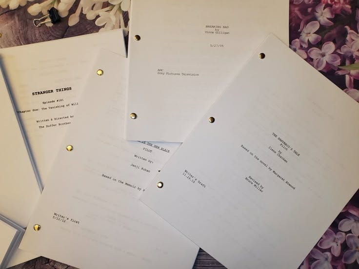 This may contain: five white papers sitting next to each other on top of a wooden table with flowers in the background