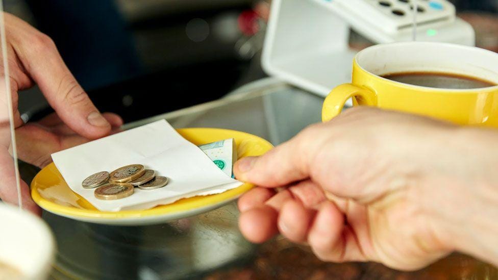 Workers must keep all tips from customers under new law - BBC News